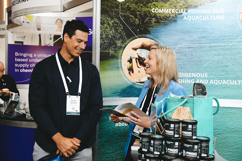 FRDC Research Portfolio Manager Adrianne Laird chats to Bryan Van-Wyk of Austral Fisheries at the FRDC stand. FRDC Research Portfolio Manager Adrianne Laird chats to Bryan Van-Wyk of Austral Fisheries at the FRDC stand.