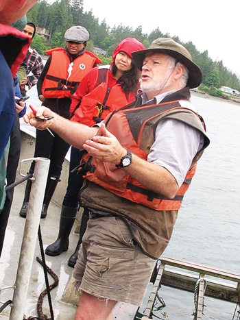 Photo of Gordon King conducting a tour about mussel productoin at Taylor Shellfish Farms, Totten Inlet Site