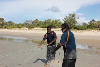 Photo of Gavin Ankin and Hans Lawrence catching fish with nets