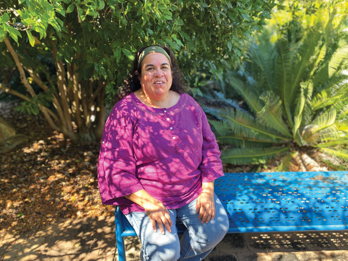 Photo of Cynthia Coyne sitting down.