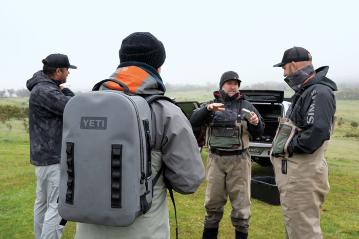 Photo of group of men in fly-fishing gear