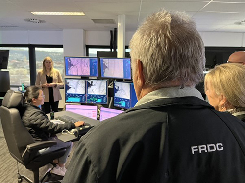 FRDC Board member observing Tassal Groups multiple monitors they they use for long-distance feeding