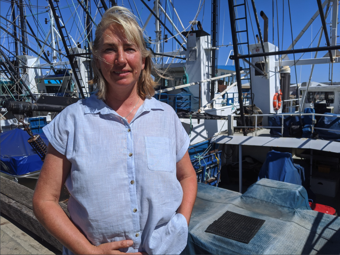 Kirsten Rough standing on wharf with boats