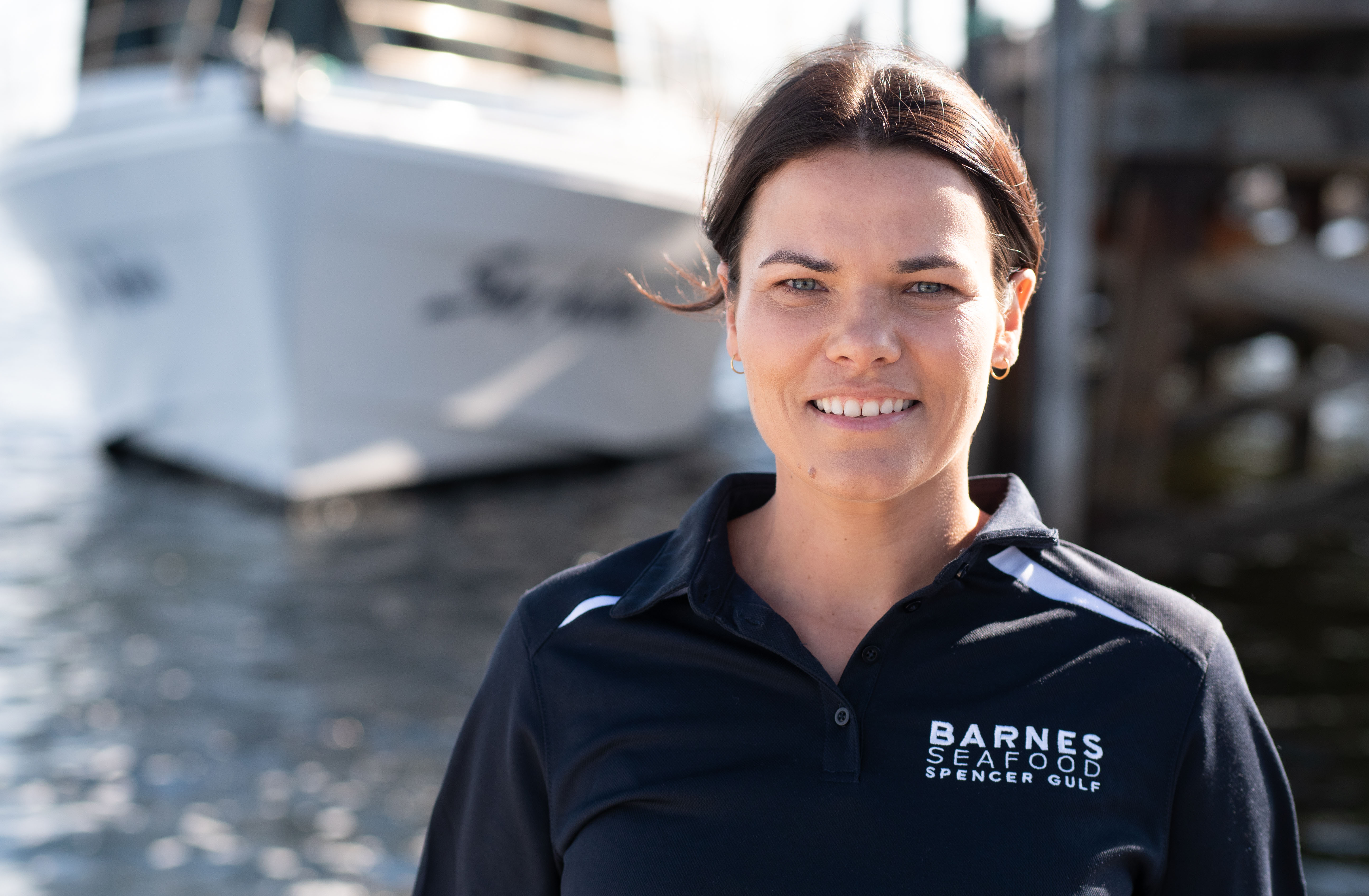 Angela Barnes standing on dock smiling 