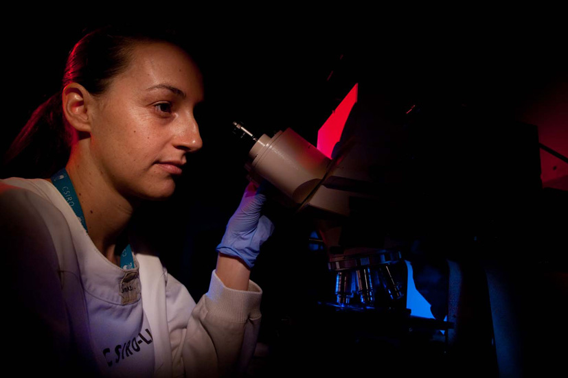 Simone Osborne staring into microscope