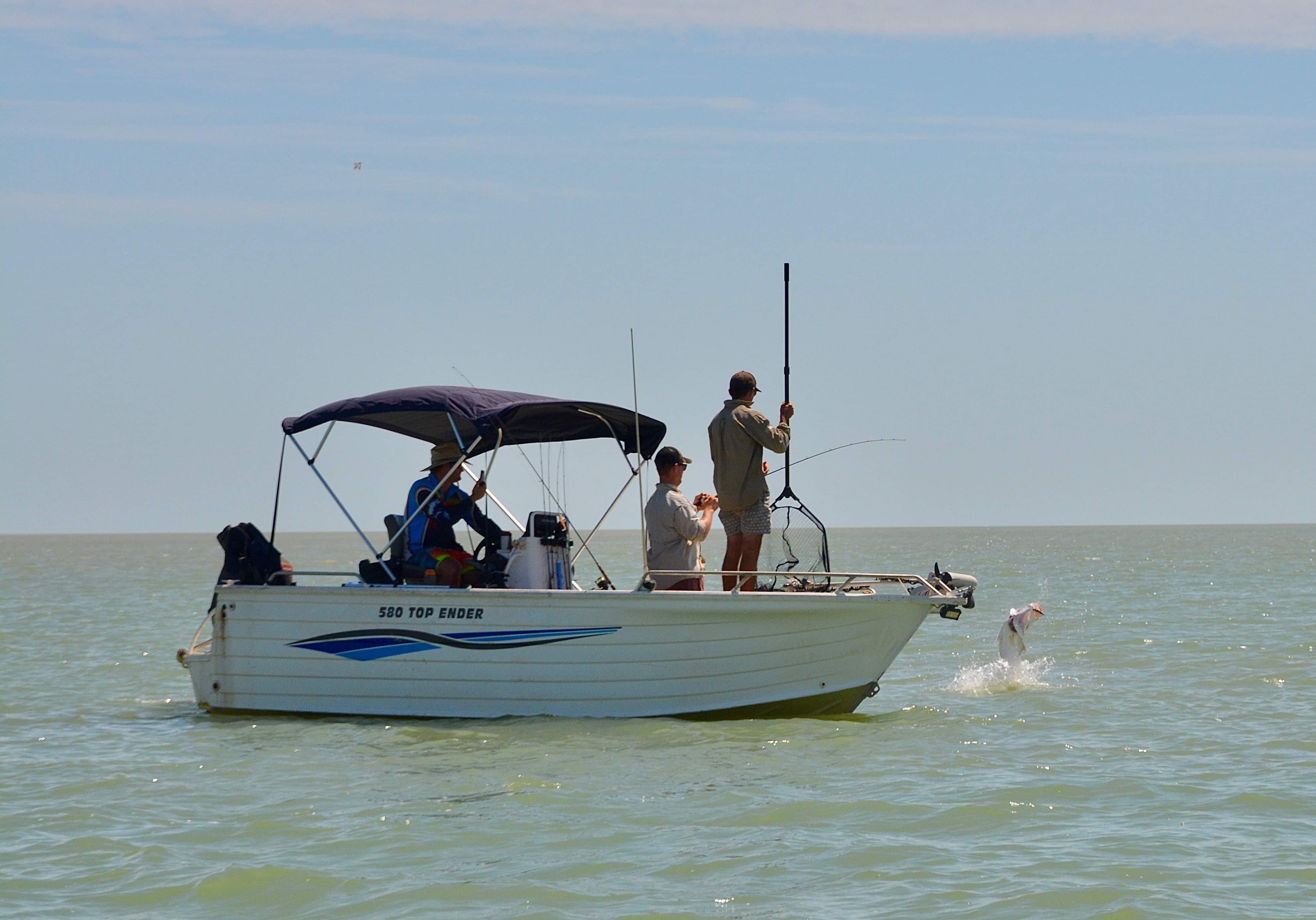Men fishing on boat for Barramundi