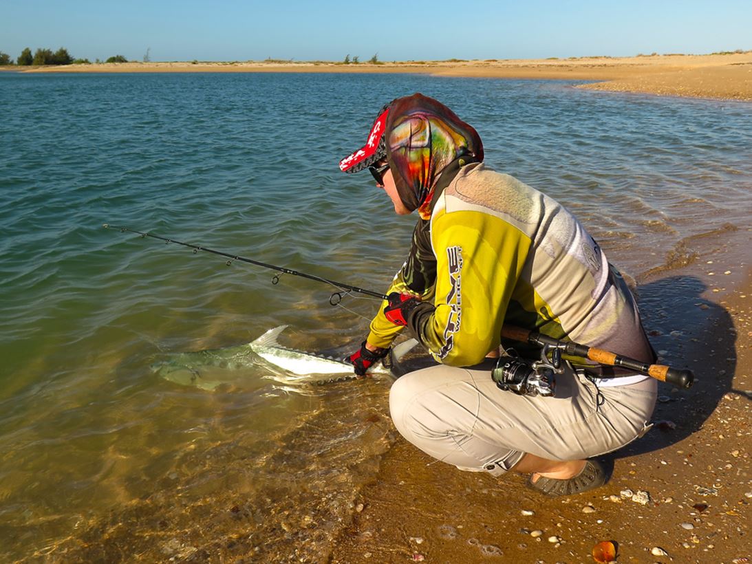 Photo of recreational fisher releasing a fish