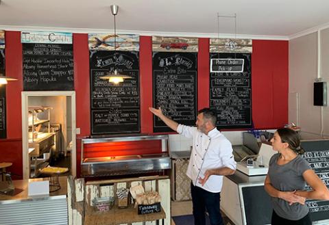 Trenton and Rebecca Brennan showcasing their menu at their Ocean to Paddock Fish & Chips shop